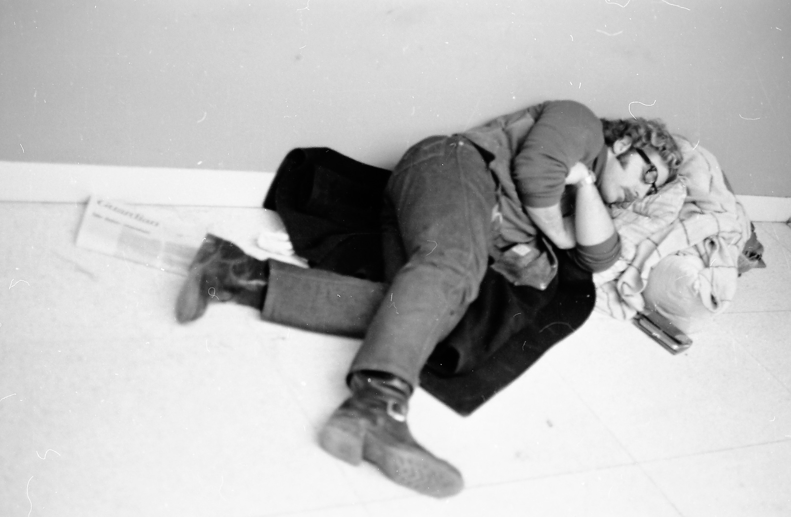 student occupier sleeping on the floor of Bernstein-Marcus Administration Center