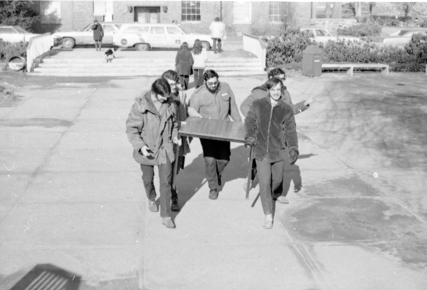 students carrying a table to Bernstein-Marcus Administration Center